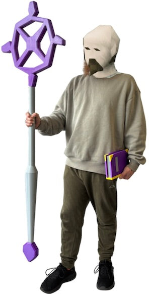 A person wearing a gray hoodie, olive pants, and black sneakers holds a large purple and gray staff-like prop while wearing a white balaclava-style mask with a fake beard. The person also holds a small purple and yellow book against a plain white background.